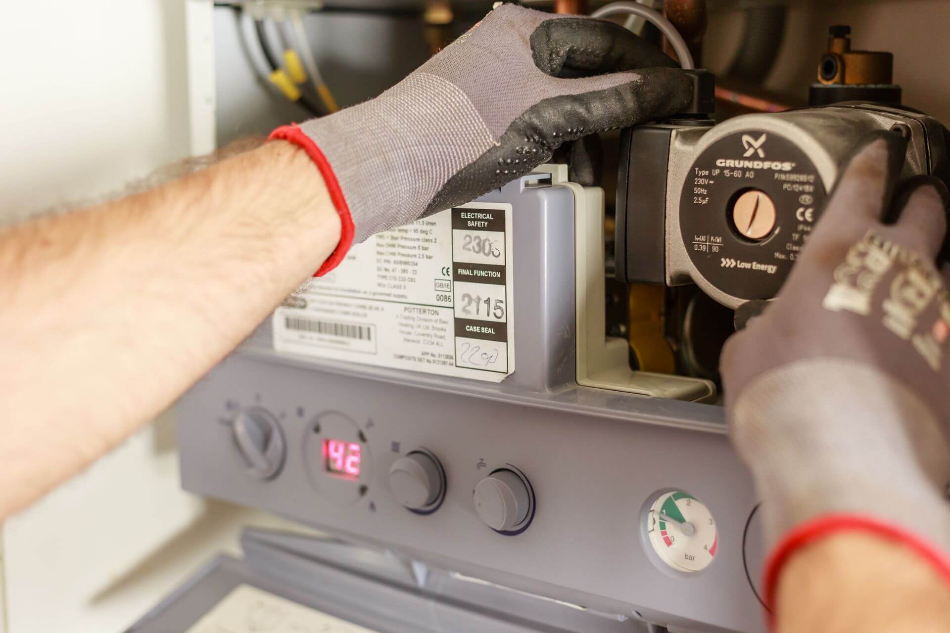 A gas engineer repairing a boiler